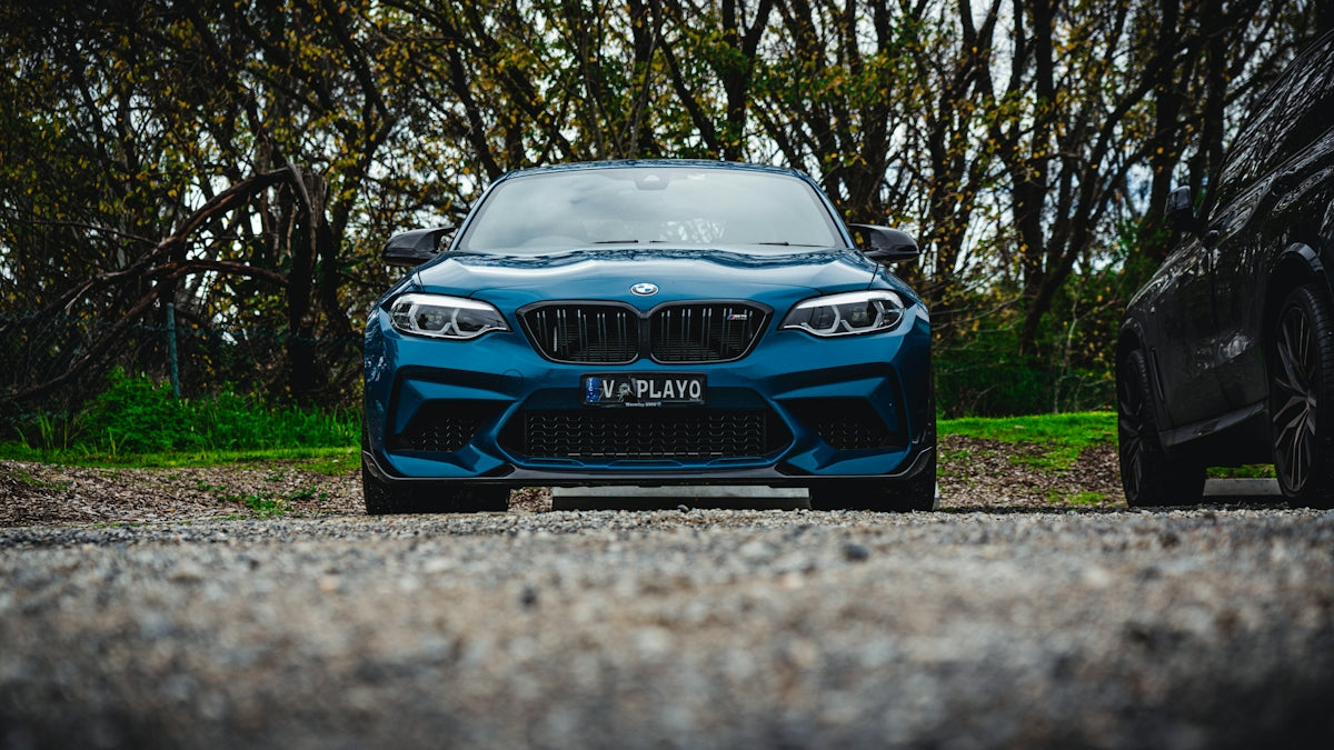 a blue car parked on a road