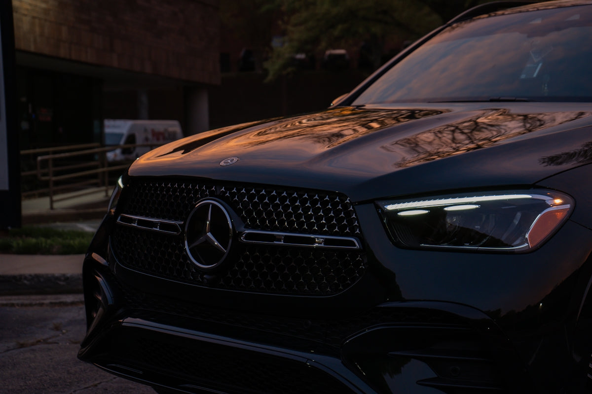 Close-up of a dark mercedes-benz suv grille.