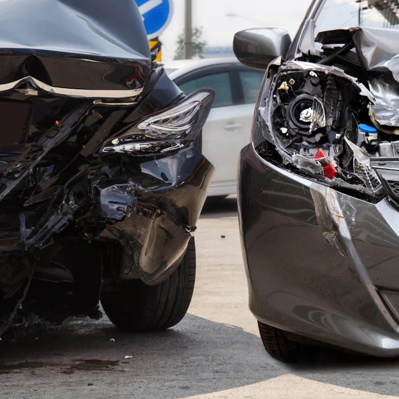 Damaged car front ends with broken headlights after crash, suitable for headlight replacement search.