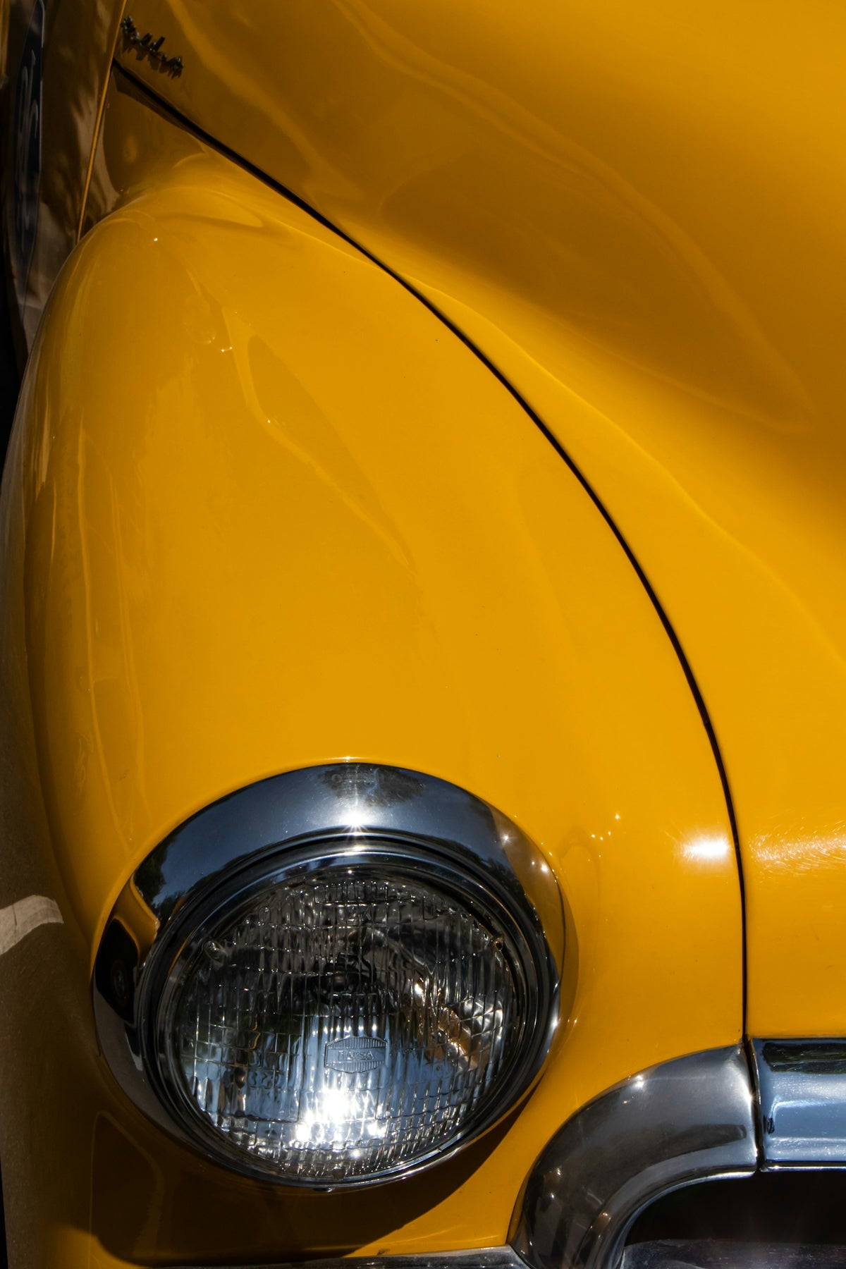 a close up of the front end of a yellow car