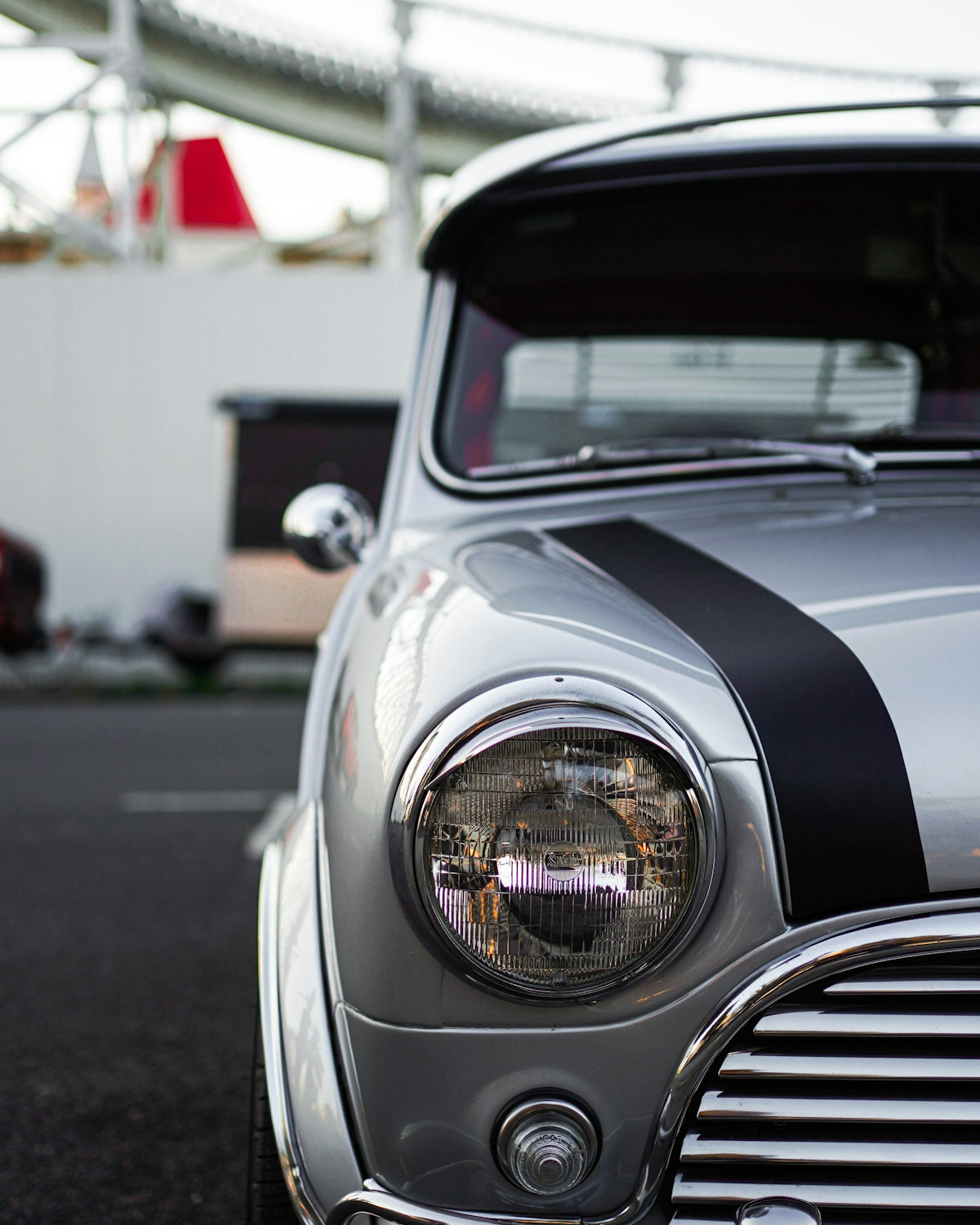 an old car with a black and white stripe on it