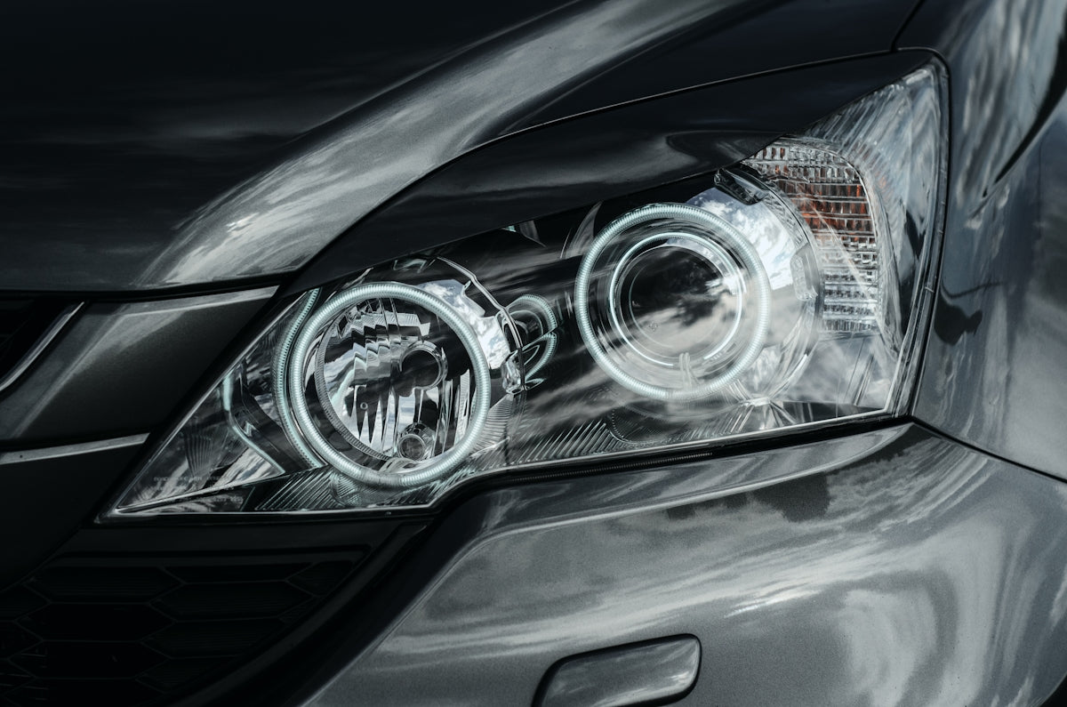 Car headlights glow brightly in the dark.