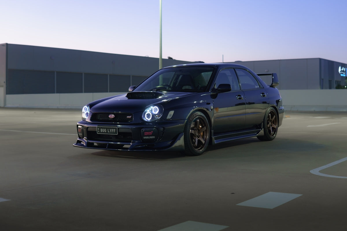 Dark blue subaru impreza wrx sti parked outside.
