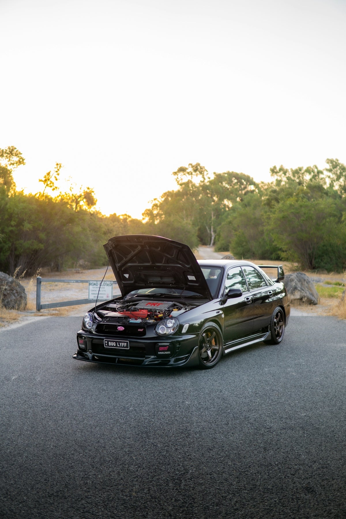 Black subaru impreza wrx sti with hood open