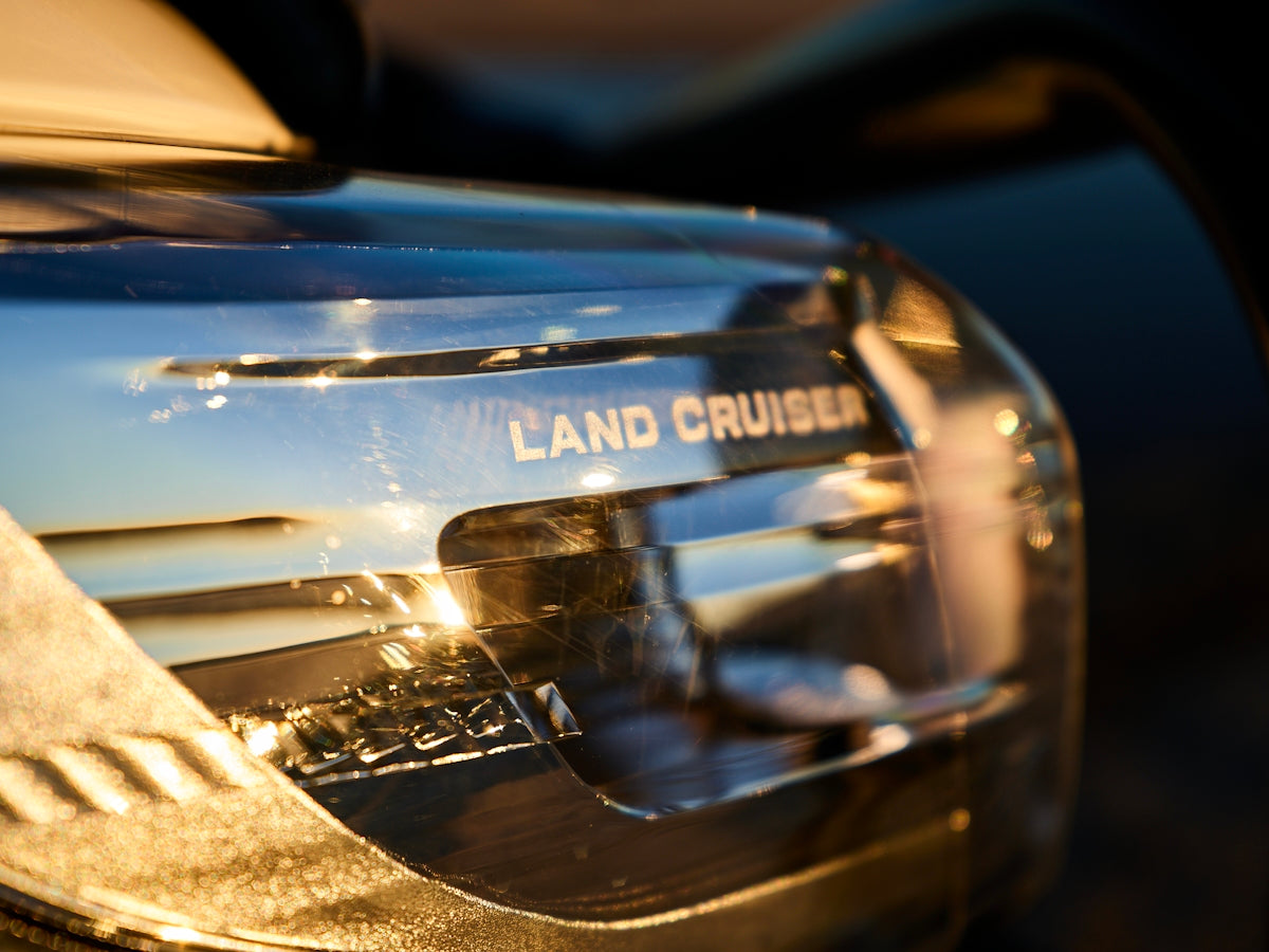 Chrome emblem on a vehicle reads land cruiser