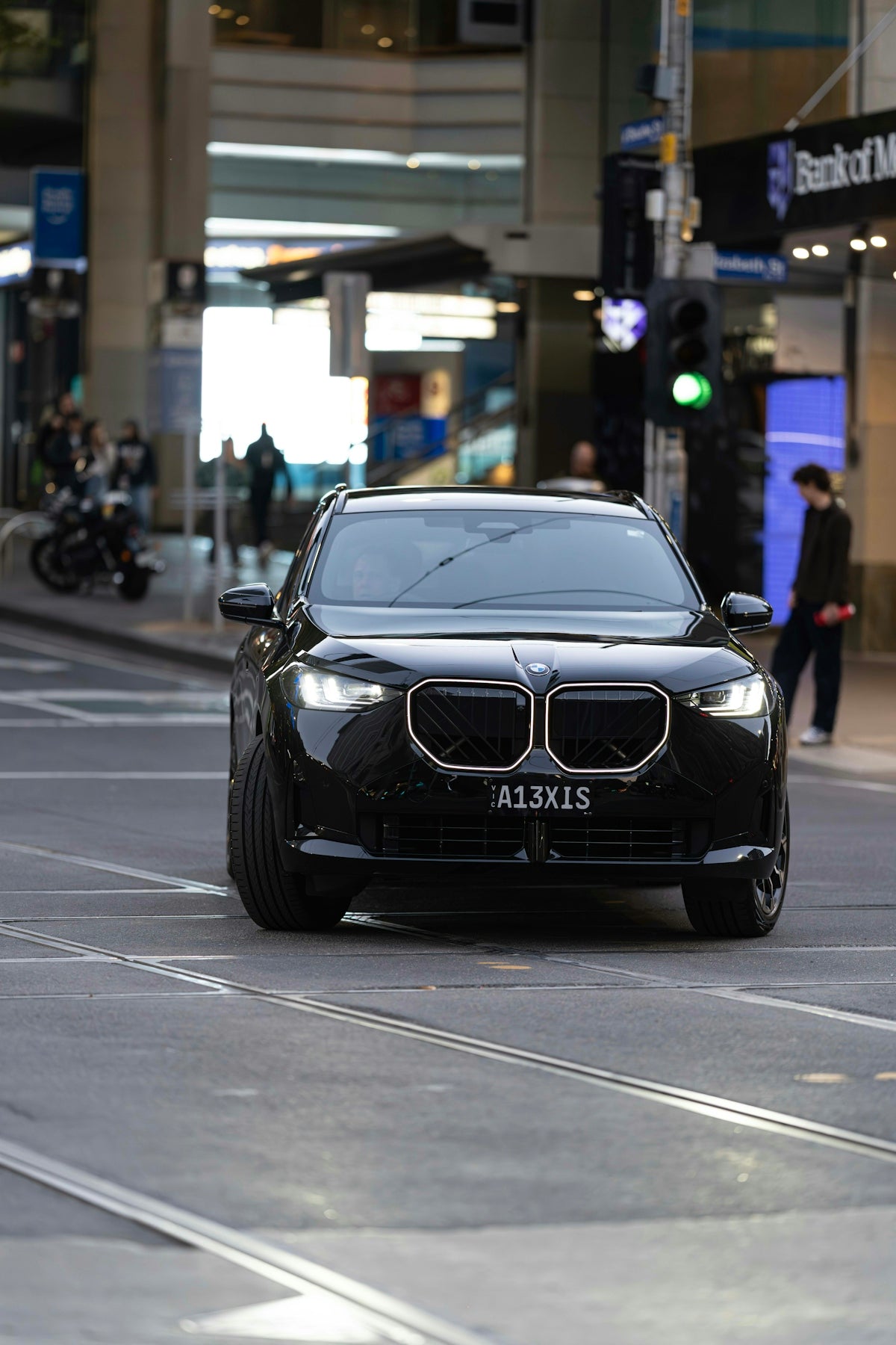 A sleek black BMW car on a city street